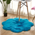 Vibrant turquoise fluffy cloud-like artificial woolen carpet rug with purple floral shape design and floral shape artificial texture