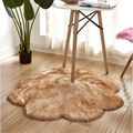 A fluffy golden-brown artificial woolen carpet rug with irregular edges complementing the purple floral shape design