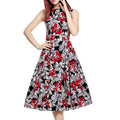 Black sleeveless vintage print dress with bold red and white floral pattern for elegant wear