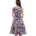 A sleeveless vintage print black dress with purple floral and silver accents featuring a fitted bodice and flared skirt