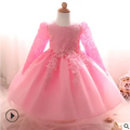 A delicate pink purple lace girls dress rose wedding dress with long sleeves lace detailing and flowing tulle skirt