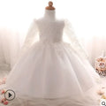 A delicate white lace long-sleeved children’s rose wedding dress with flowing tulle skirt and floral embroidery