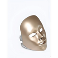 Gold-colored sleek purple led mask facial beauty device with smooth metallic finish and precise cutouts for fine lines treatment