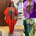 Vibrant orange dashiki-style dress with intricate black and gold floral embroidery in purple patterned ethnic style loose plus size design