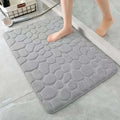 Gray pebble-textured bath mat with a soft plush surface from the purple pebble 3 piece bathroom rug set