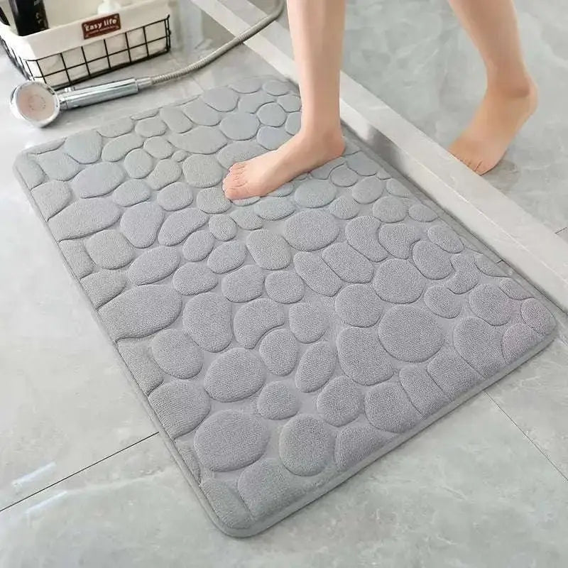 Gray pebble-textured bath mat with a soft plush surface from the purple pebble 3 piece bathroom rug set