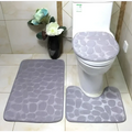 Gray pebble-patterned bathroom rug set including toilet lid cover from the purple pebble 3 piece collection