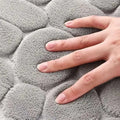 Soft gray plush bath mat with textured circular pattern from purple pebble 3 piece bathroom rug set including toilet lid cover