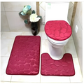 Set of three red pebble textured bathroom rug set with matching toilet lid cover for coordinated bathroom decor