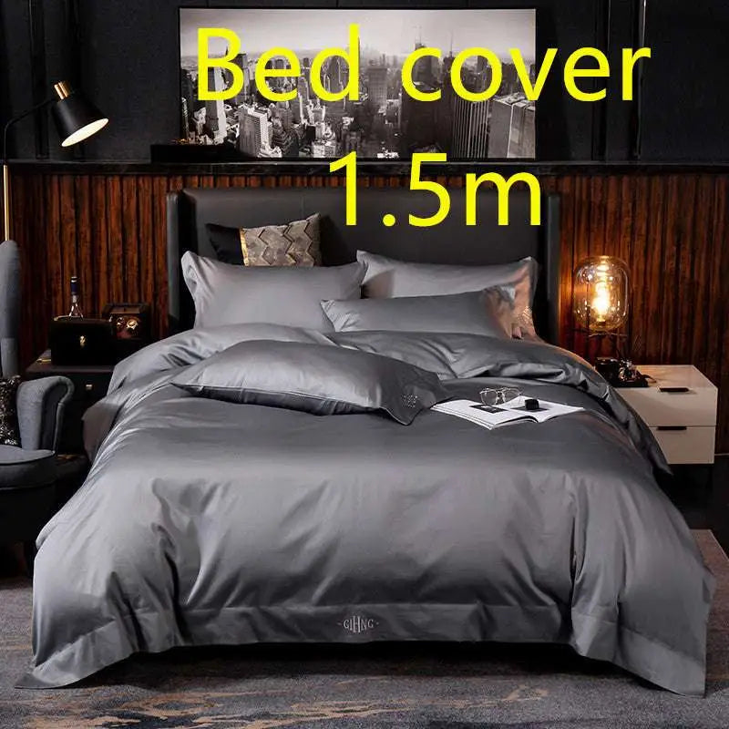 Dark gray satin bed cover with subtle sheen and embroidered logo at the foot in a purple satin embroidered four-piece set