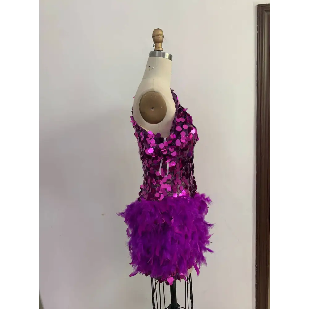 Purple sequined feather sleeve short dress displayed on a mannequin featuring vibrant feathers and sequins