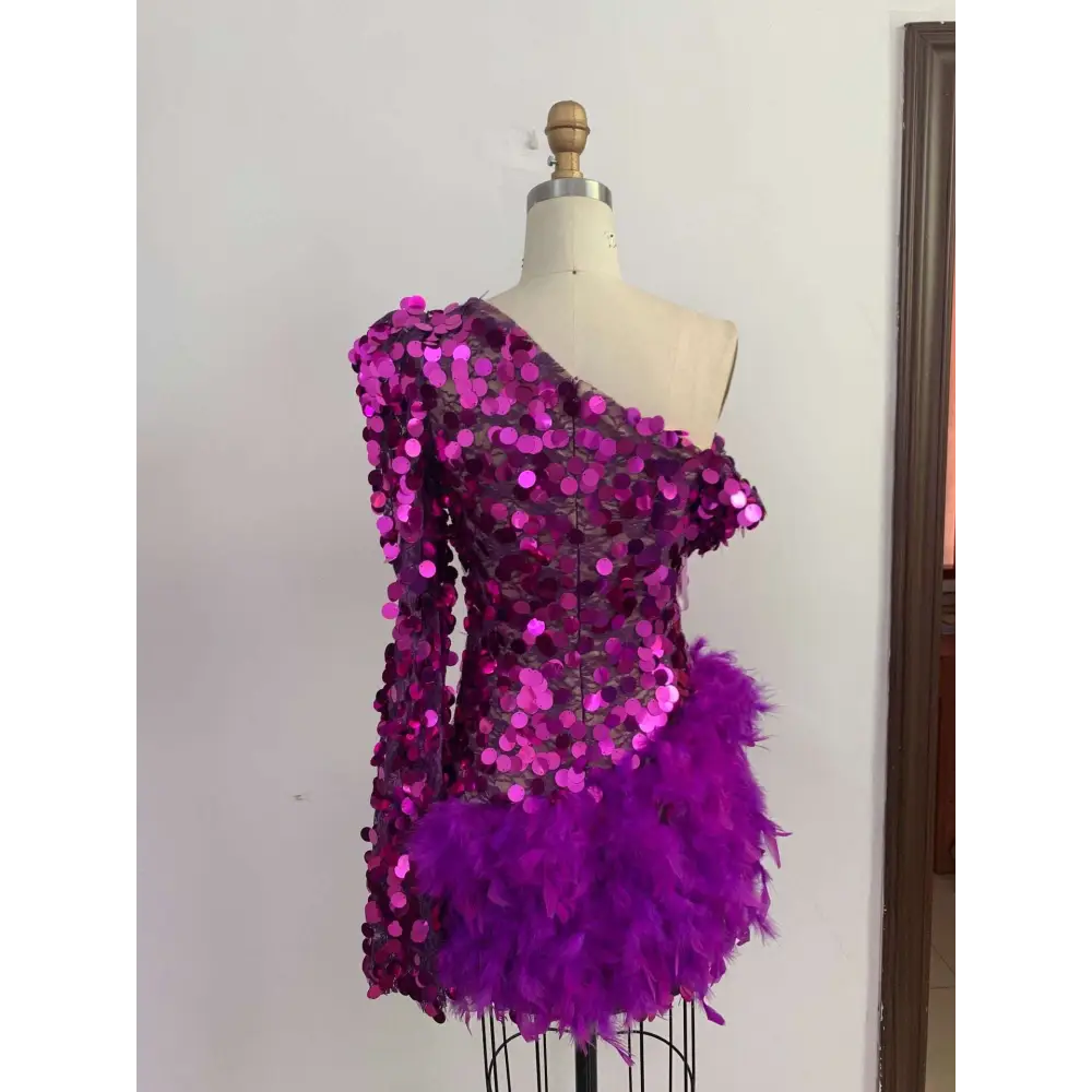 A vibrant magenta purple sequined feather one-shoulder short dress with a feathered hemline and sequined feather skirt