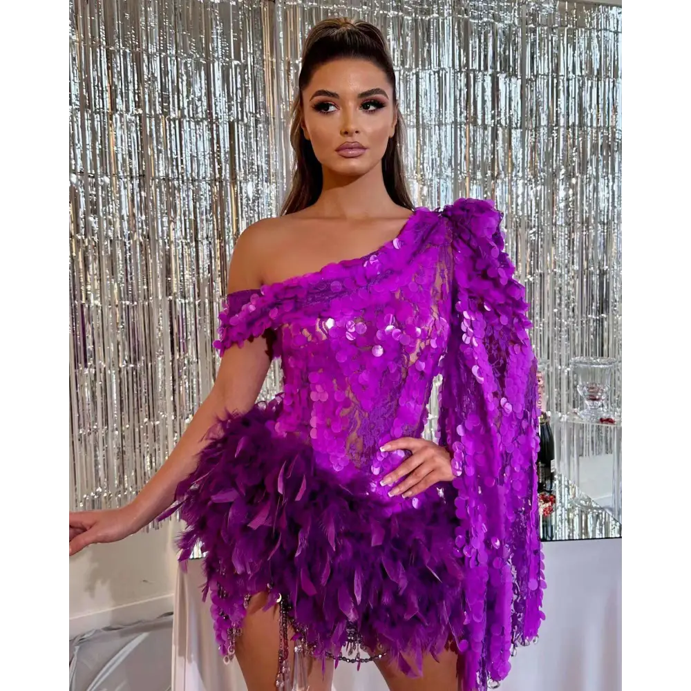 A vibrant purple sequined feather sleeve short dress with one shoulder design and feather embellishments