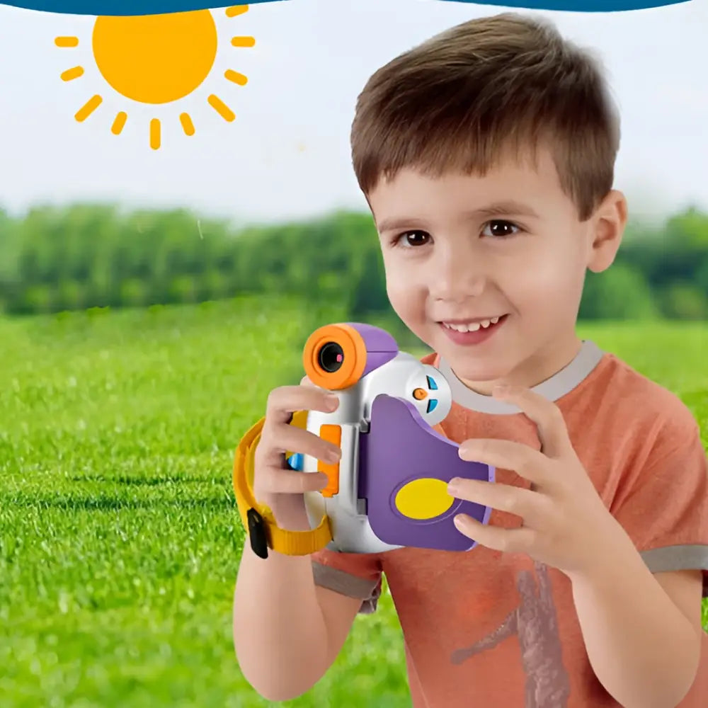 A child holds a purple silver childrens digital video camera with colorful purple orange and white plastic parts