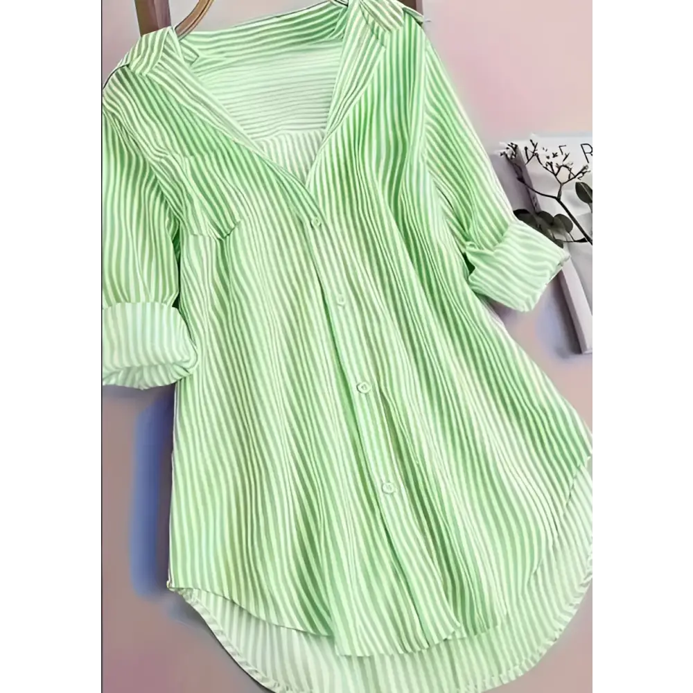 A light green and white vertically striped long sleeve blouse with rolled sleeves in a purple stripe casual style