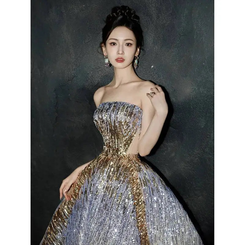 Purple tube embossed toast dress with a shimmering silver and gold sequined strapless ball gown design and voluminous skirt