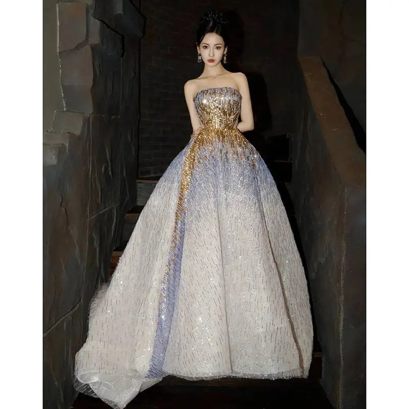 Purple tube embossed toast dress with a strapless gold sequined bodice and flowing silver to lavender skirt with sequins
