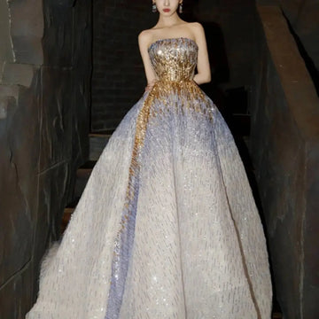 Strapless purple tube embossed toast dress with a gold sequined bodice and lavender white glittery voluminous skirt