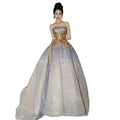 Purple tube embossed toast dress featuring a gold sequined strapless bodice and a flowing lavender and white sheer skirt