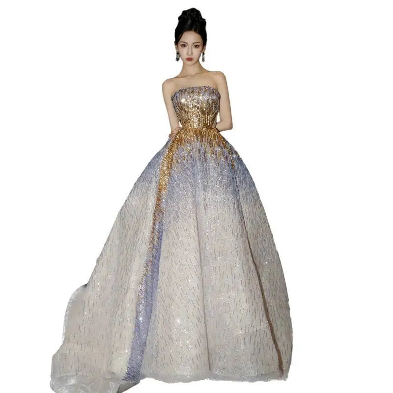 Purple tube embossed toast dress featuring a gold sequined strapless bodice and a flowing lavender and white sheer skirt