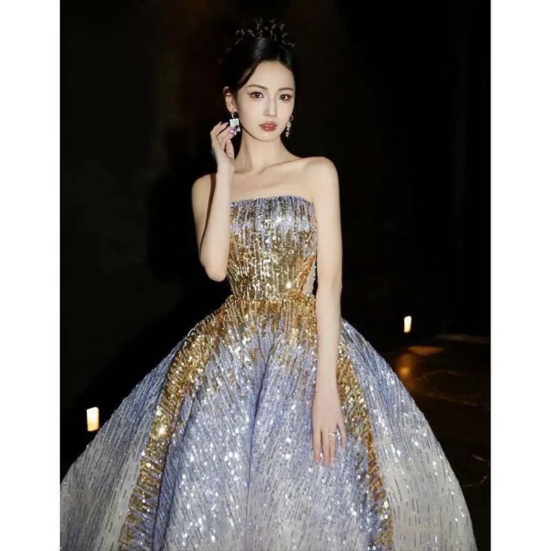 A purple tube embossed toast dress featuring a strapless voluminous ball gown with silver and gold sequined design