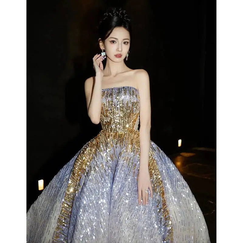 A purple tube embossed toast dress with a shimmering strapless ball gown design featuring gold sequined gradient