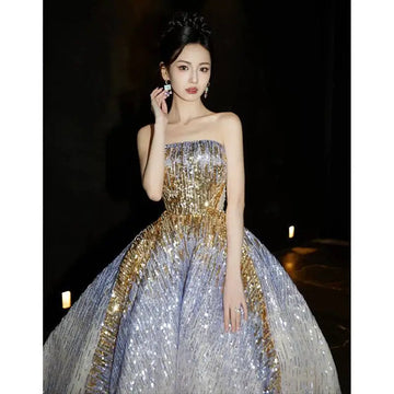 A purple tube embossed toast dress with a shimmering strapless ball gown design featuring gold sequined gradient