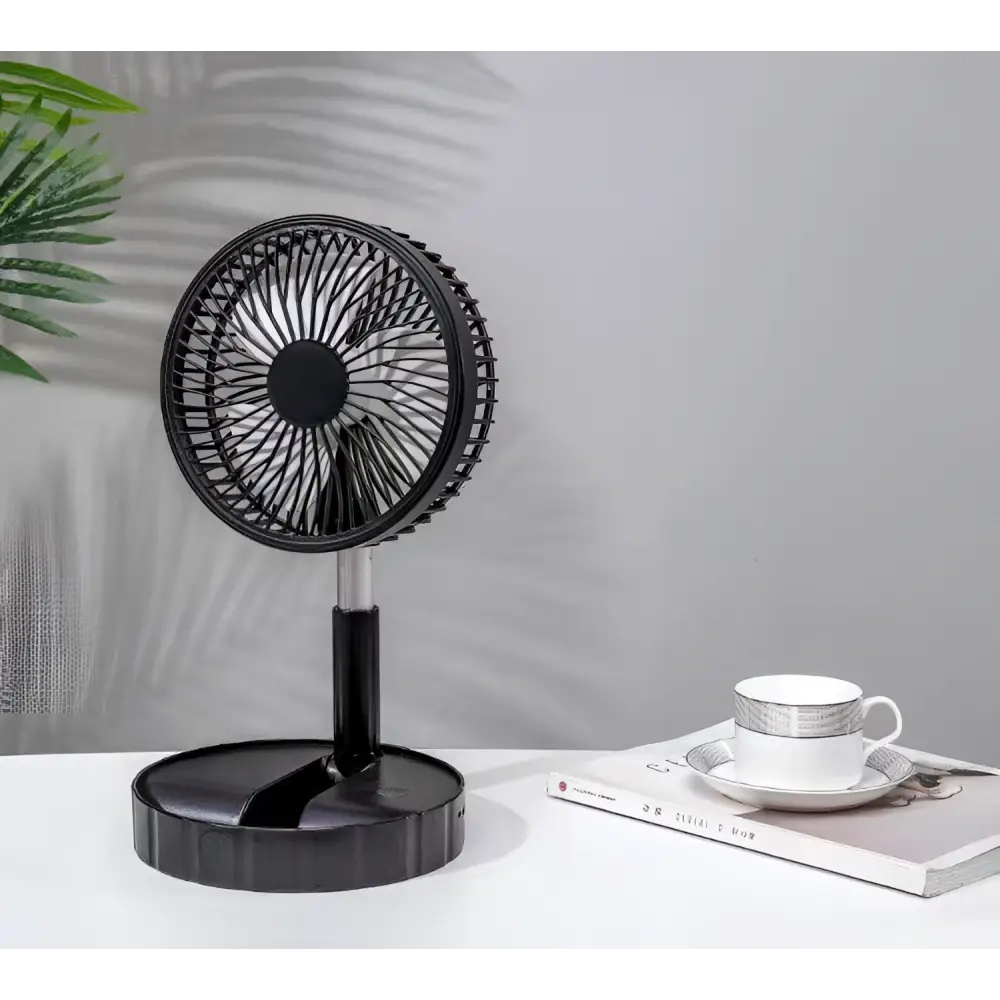 Black portable telescopic folding fan with circular grille and sleek modern design on slender stand for quiet use