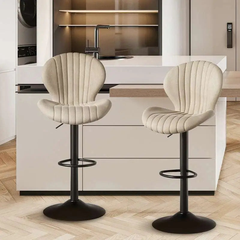 Quilted cream velvet upholstered bar stool with black metal base and footrest offering luxury women’s fashion comfort