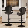 Black upholstered bar stools with vertical stitching and sleek metal bases complement quilted cream velvet luxury womens fashion