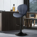 A sleek dark gray upholstered bar stool with a ribbed design and black metal base complementing luxury women’s fashion