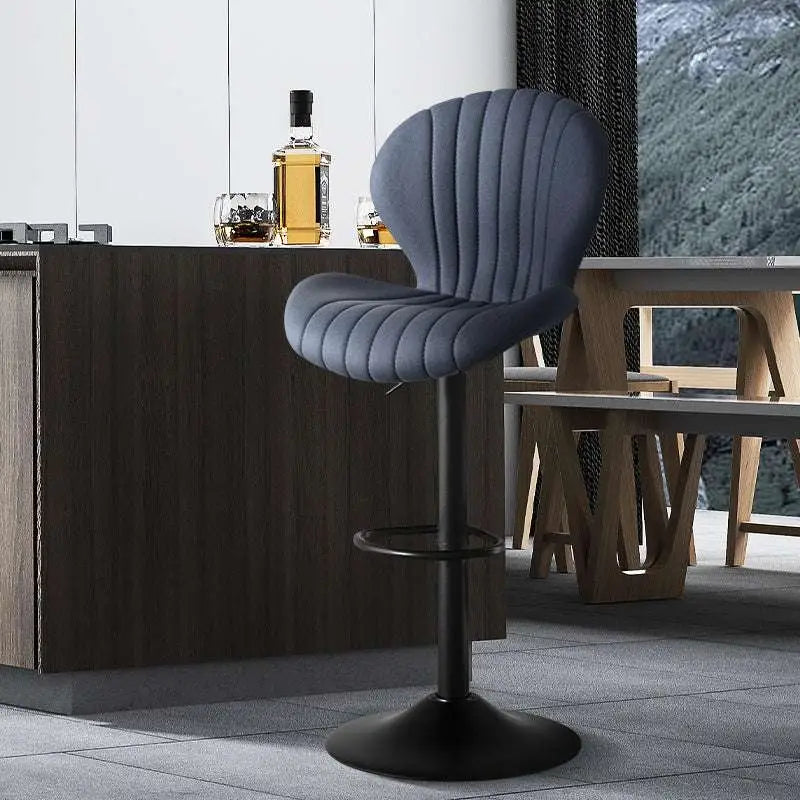 A sleek dark gray upholstered bar stool with a ribbed design and black metal base complementing luxury women’s fashion