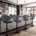 Modern gray upholstered bar stools with sleek black metal bases and adjustable height for luxury women’s fashion settings