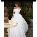 A flowing white tutu wedding dress with raglan sleeve long sheer sleeves and intricate lace bodice detailing