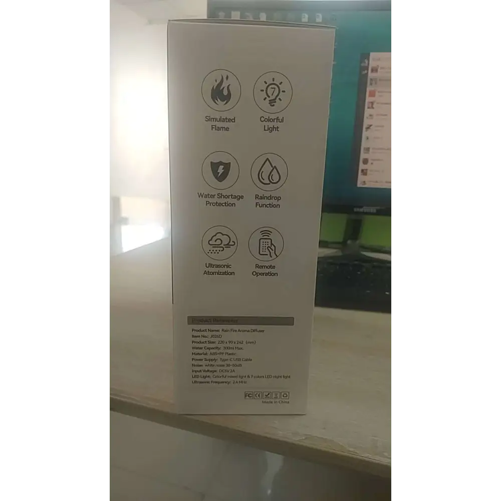 White cardboard box for rain cloud humidifier aroma diffuser featuring fire arming icons and colorful light effects