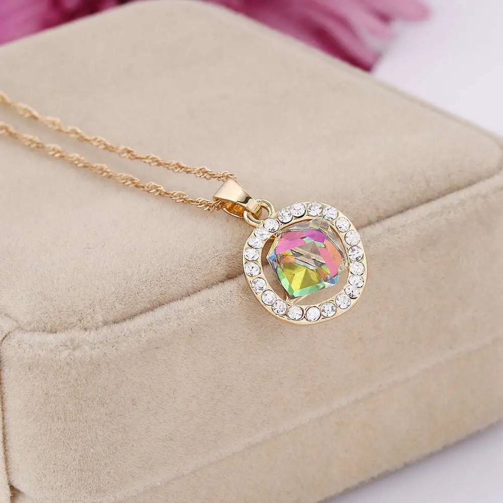 Gold-toned crystal bridal necklace with round rainbow crystal pendant and clear rhinestones in earrings set