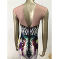 Back view of a soft pink sequin evening dress with deep v-back and rainbow gradient sequin pattern for female singer costume