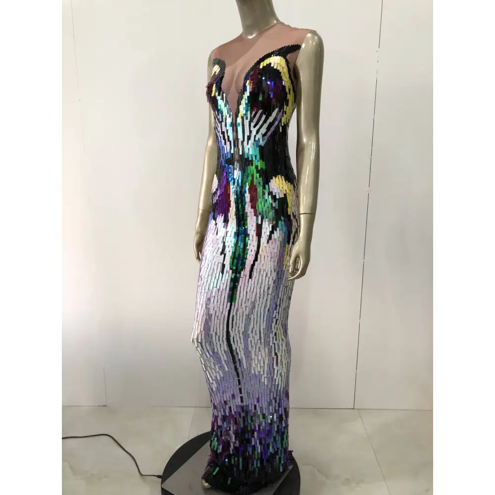 A shimmering floor-length sequin evening dress with a rainbow gradient in black purple green and gold for female singer costume