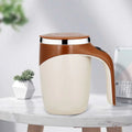 Cream-colored ceramic rechargeable model automatic stirring cup with brown handle lid and metallic rim for convenience