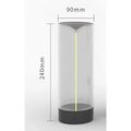 A sleek rechargeable portable night light led camping light with a transparent cylinder and black base