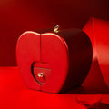 Red apple jewelry box in a heart shape with metallic clasp and small drawer featuring a heart cutout for eternal rose and clavicle chain storage