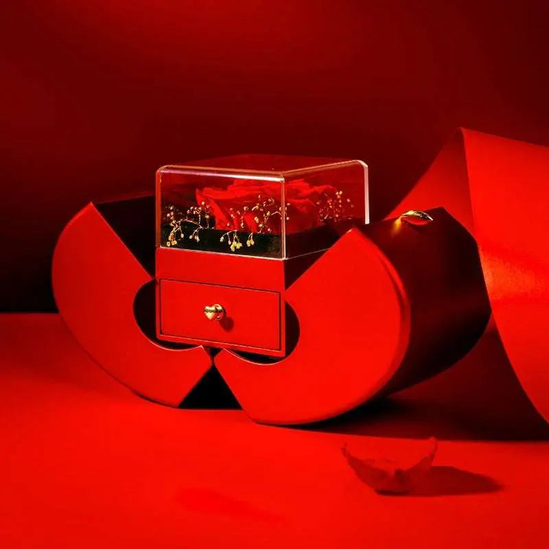 Red apple jewelry box in sleek red leather with a transparent top showcasing eternal rose and clavicle chain
