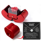 Red apple jewelry box with red metallic heart shape and clear acrylic lid containing an eternal rose and clavicle chain