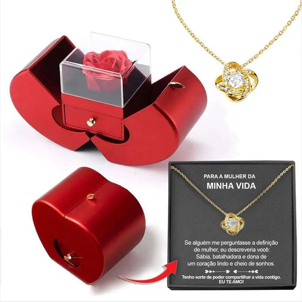 Red apple jewelry box with clear acrylic lid revealing an eternal rose and clavicle chain necklace inside