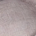Beige linen-textured cushion with subtle woven pattern complementing red bow fascinator for ladies banquet ball with feather accents