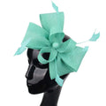 A mint green ladies banquet ball fascinator featuring a large textured bow and delicate feather accents