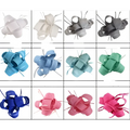 A collection of elegant woven ladies banquet ball hats with feather accents including a red bow fascinator in various colors