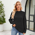 Black cable knit pullover sweater with textured diamond pattern and ribbed cuffs for fall winter wear