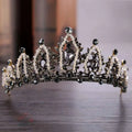 An ornate black and silver crystal alloy crown wedding accessory adorned with clear and dark gemstones in a regal design