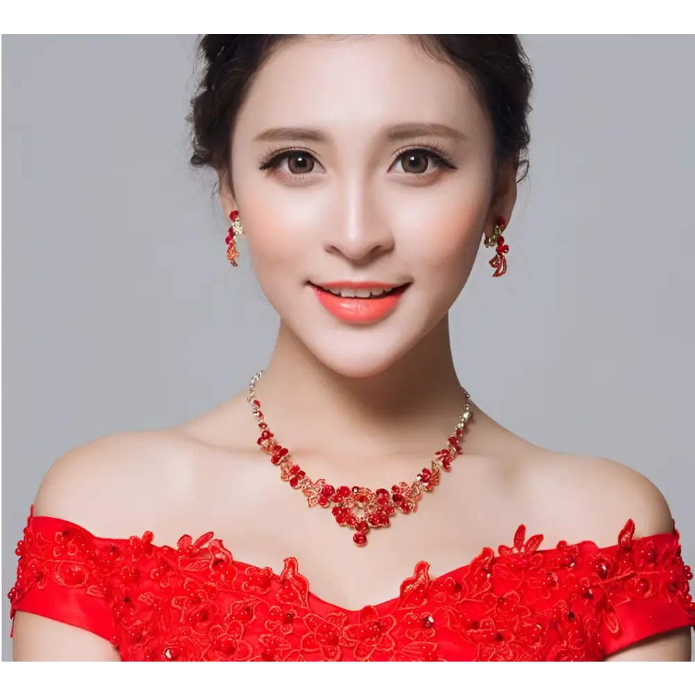 Red crystal bridal jewelry featuring a red beaded necklace with gold-toned accents and floral charms clothing accessories wholesale